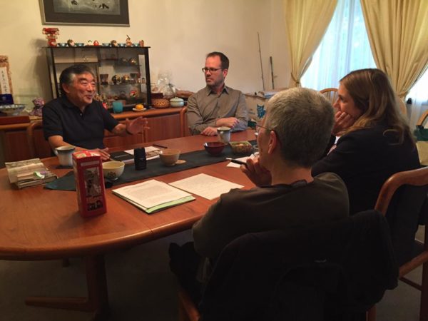 Photo of Tetsu Kashima speaking with Mission US team members